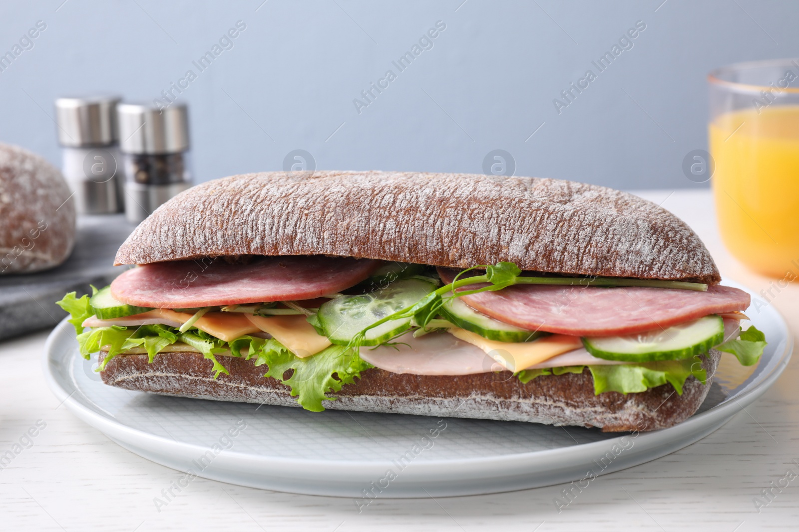 Photo of Tasty sandwich with ham served on white wooden table