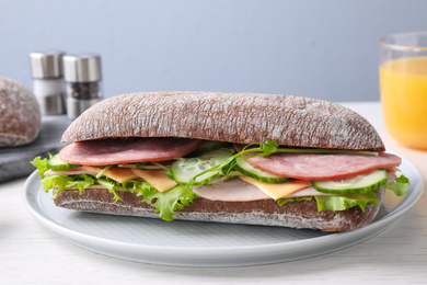 Photo of Tasty sandwich with ham served on white wooden table