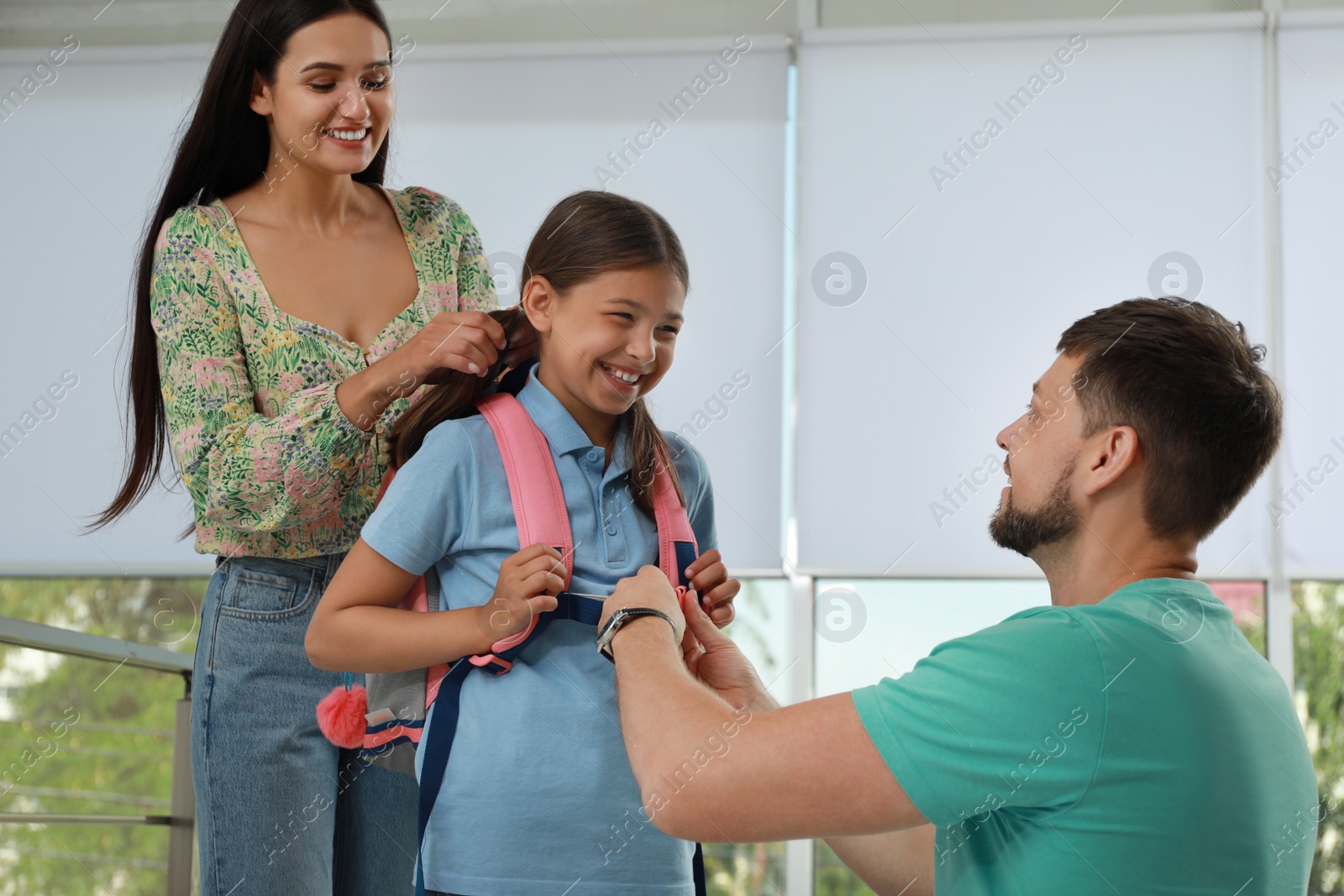 Photo of Parents saying goodbye to their daughter in school