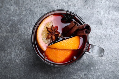 Aromatic mulled wine on grey table, top view