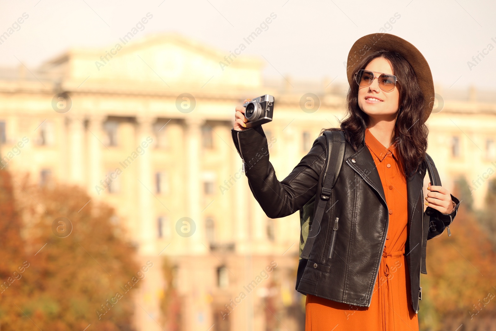 Photo of Traveler with photo camera on city street