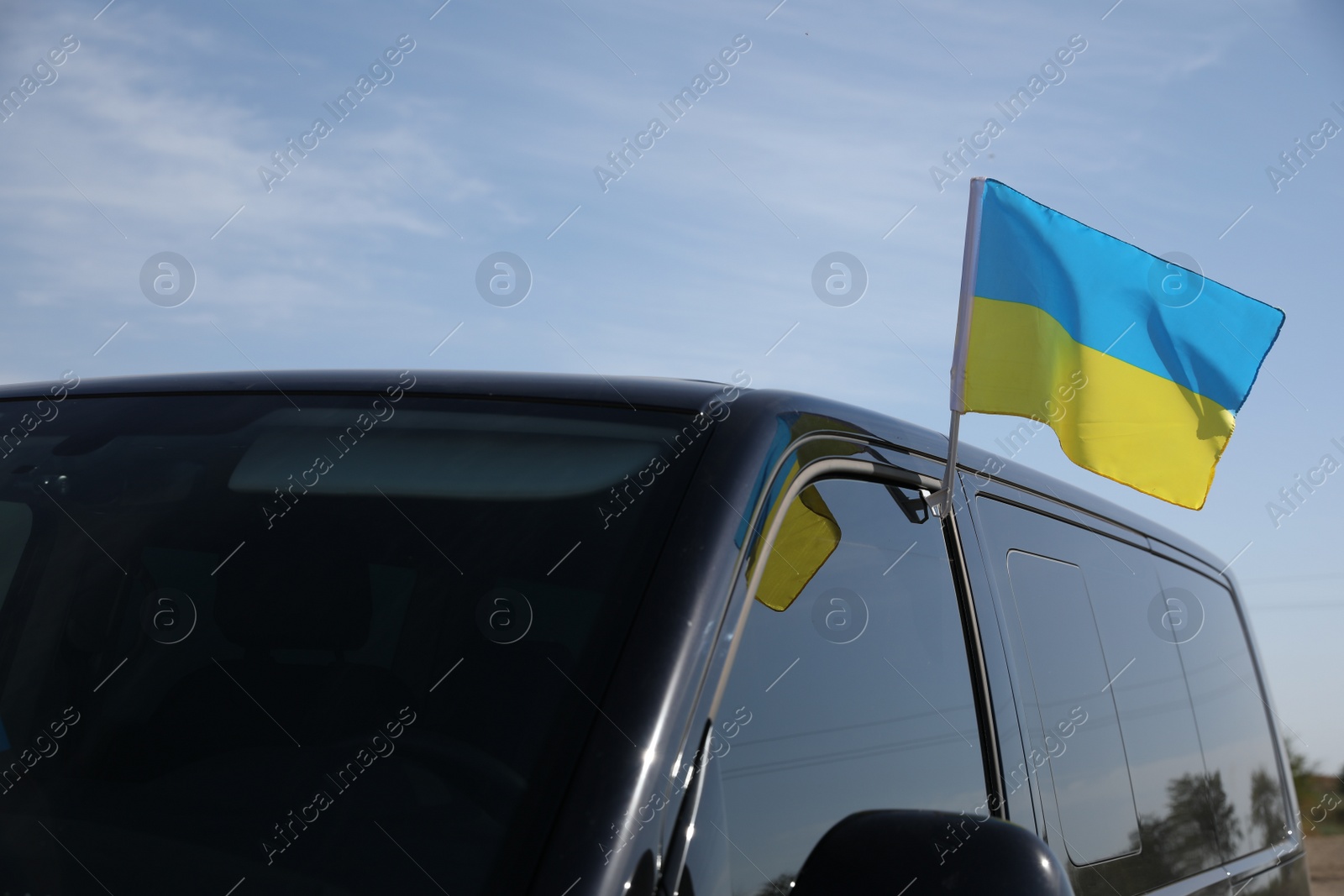 Photo of National flag of Ukraine on car window outdoors