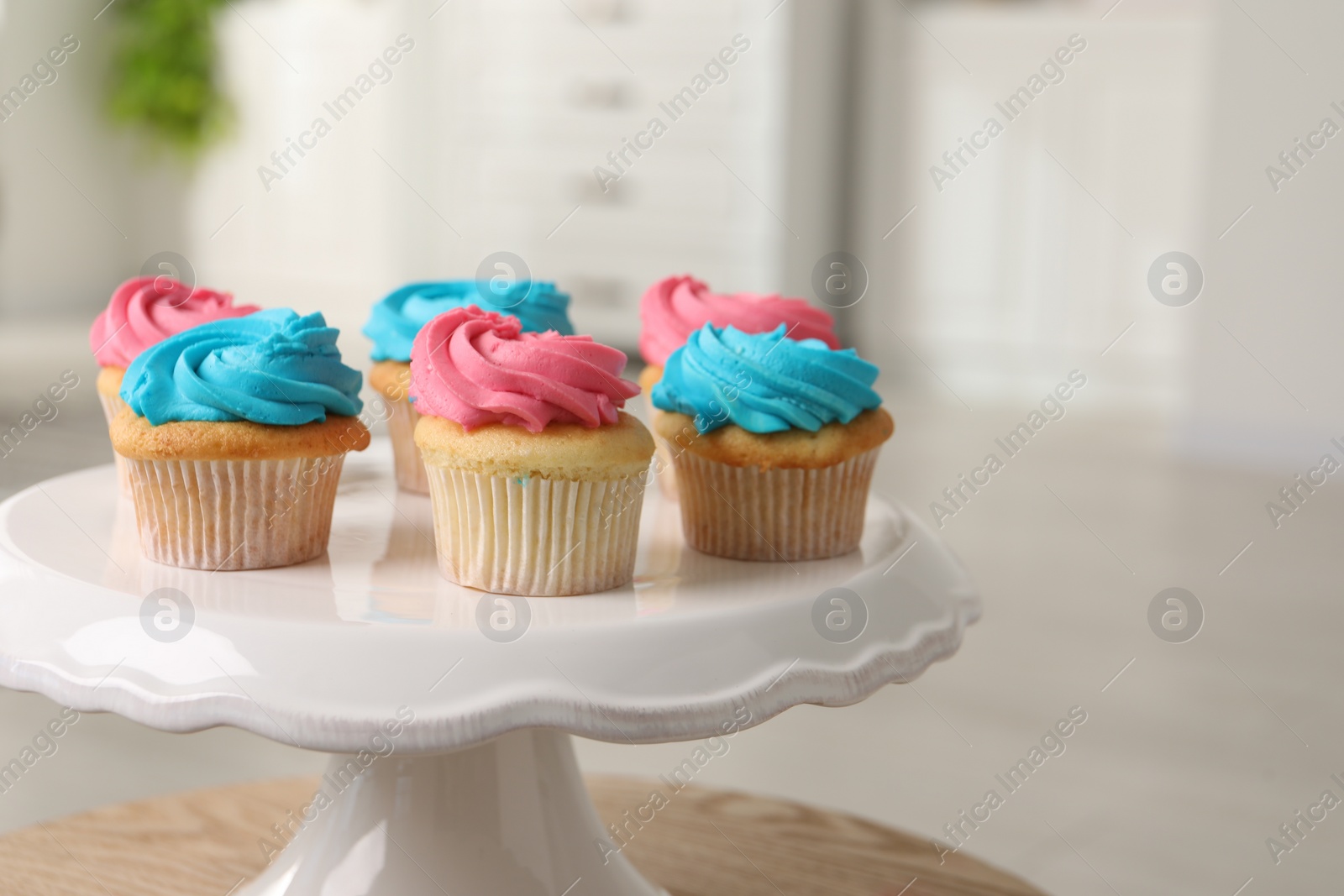 Photo of Delicious cupcakes with bright cream on table indoors, closeup. Space for text