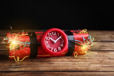 Image of Dynamite time bomb with burning wires on wooden table
