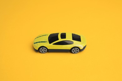 Photo of One bright car on yellow background. Children`s toy