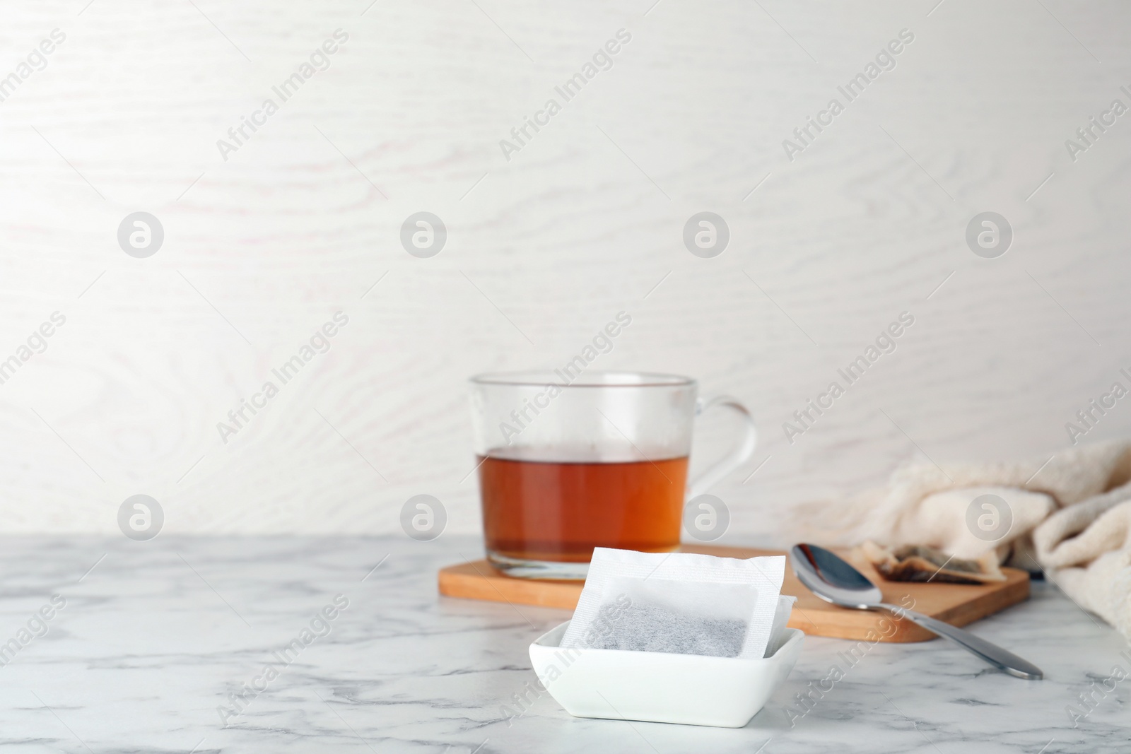 Photo of Bowl with tea bags on table. Space for text