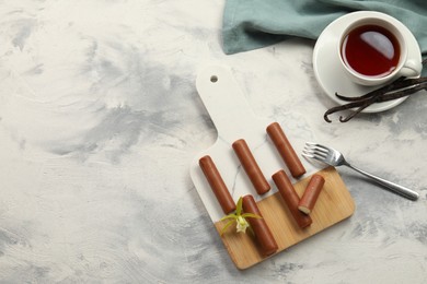 Photo of Glazed vanilla curd cheese bars served on light textured table, flat lay. Space for text