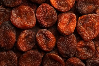 Tasty dried apricots as background, top view. Healthy snack