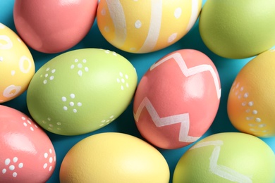 Photo of Many beautiful painted Easter eggs as background, top view