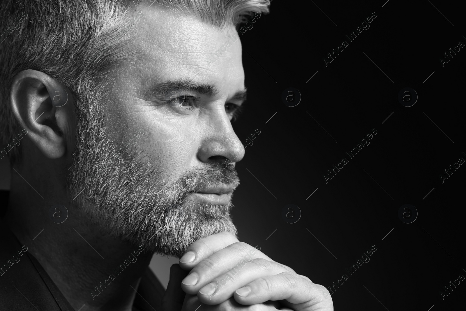 Photo of Portrait of handsome man on dark background, space for text. Black and white effect