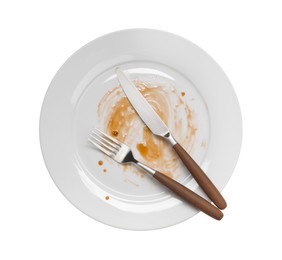 Dirty plate and cutlery on white background, top view