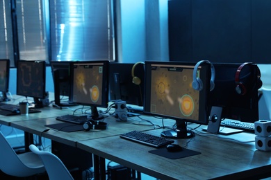 Photo of Internet cafe interior with modern computers. Video game tournament