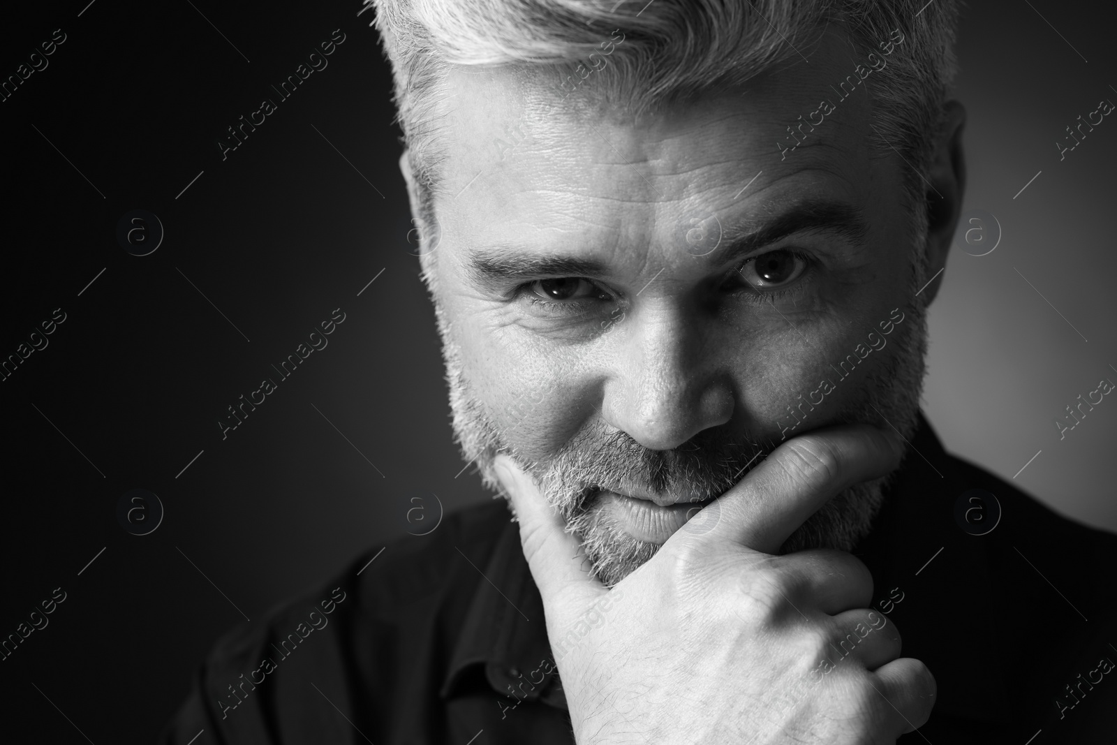 Photo of Portrait of handsome man on dark background, space for text. Black and white effect