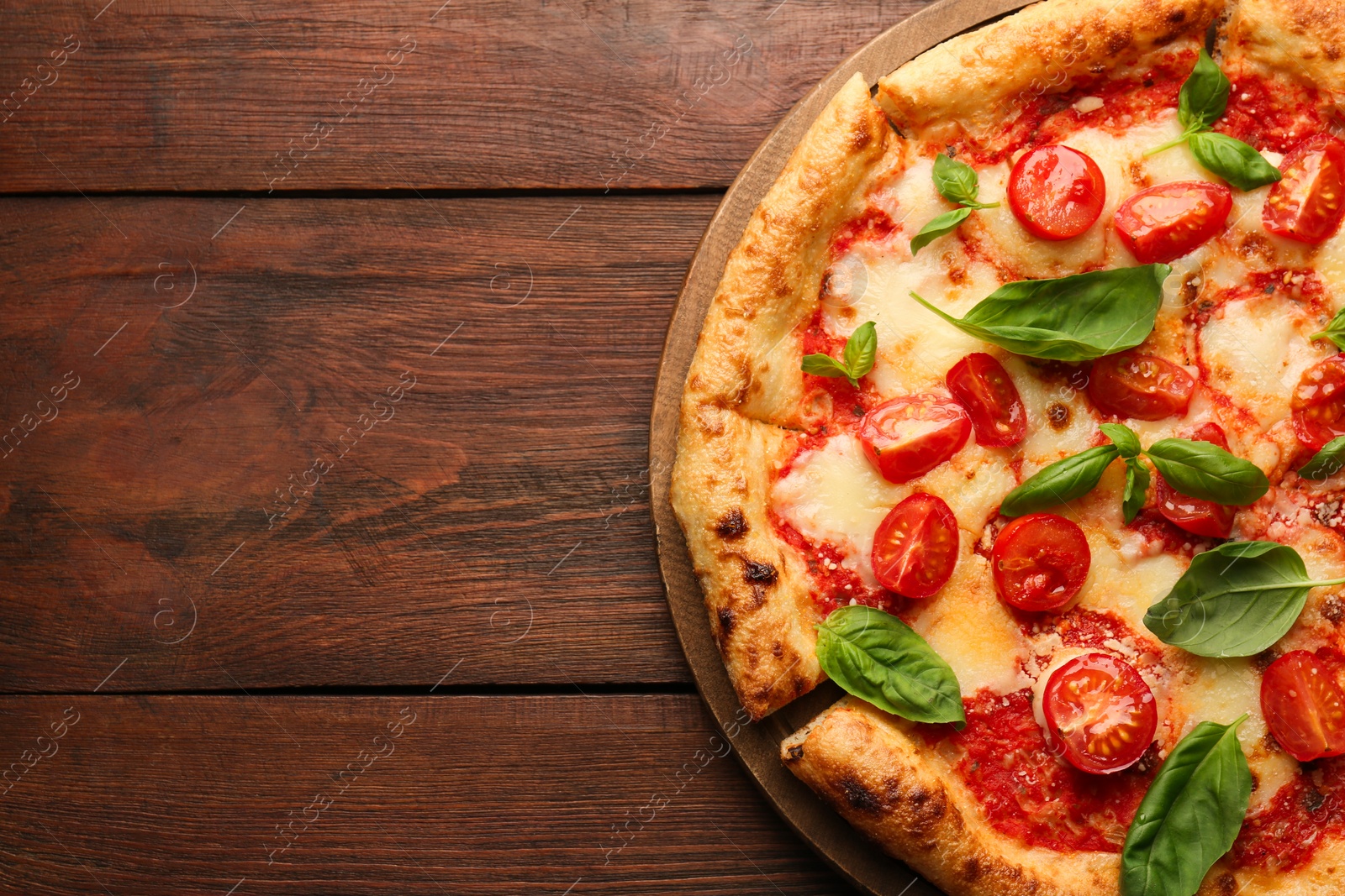 Photo of Delicious Margherita pizza on wooden table, top view. Space for text