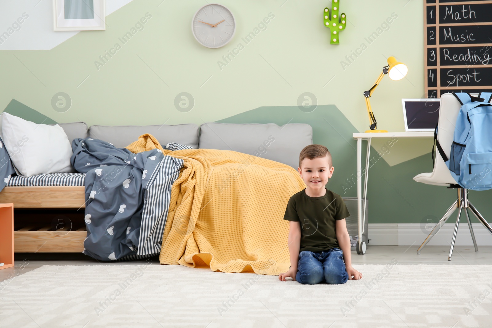 Photo of Cute little boy at home. Modern child room interior