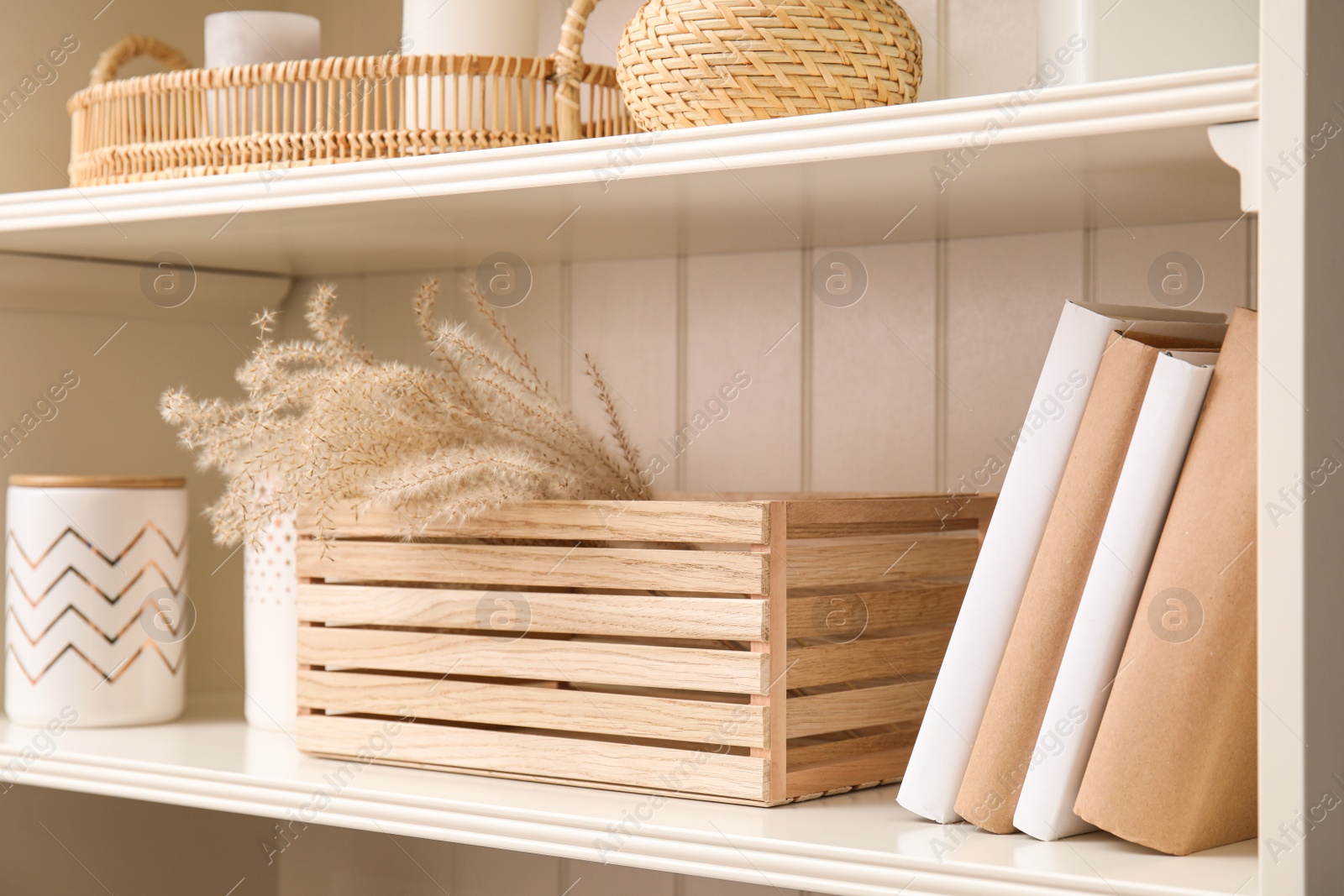 Photo of White shelving unit with books and different decorative stuff