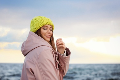 Portrait of beautiful young woman near sea