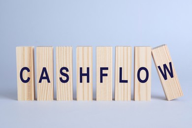 Image of Wooden blocks with phrase Cash FLow on light grey background