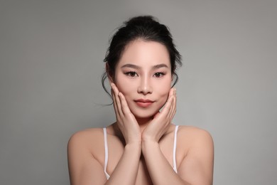 Photo of Portrait of beautiful woman on grey background