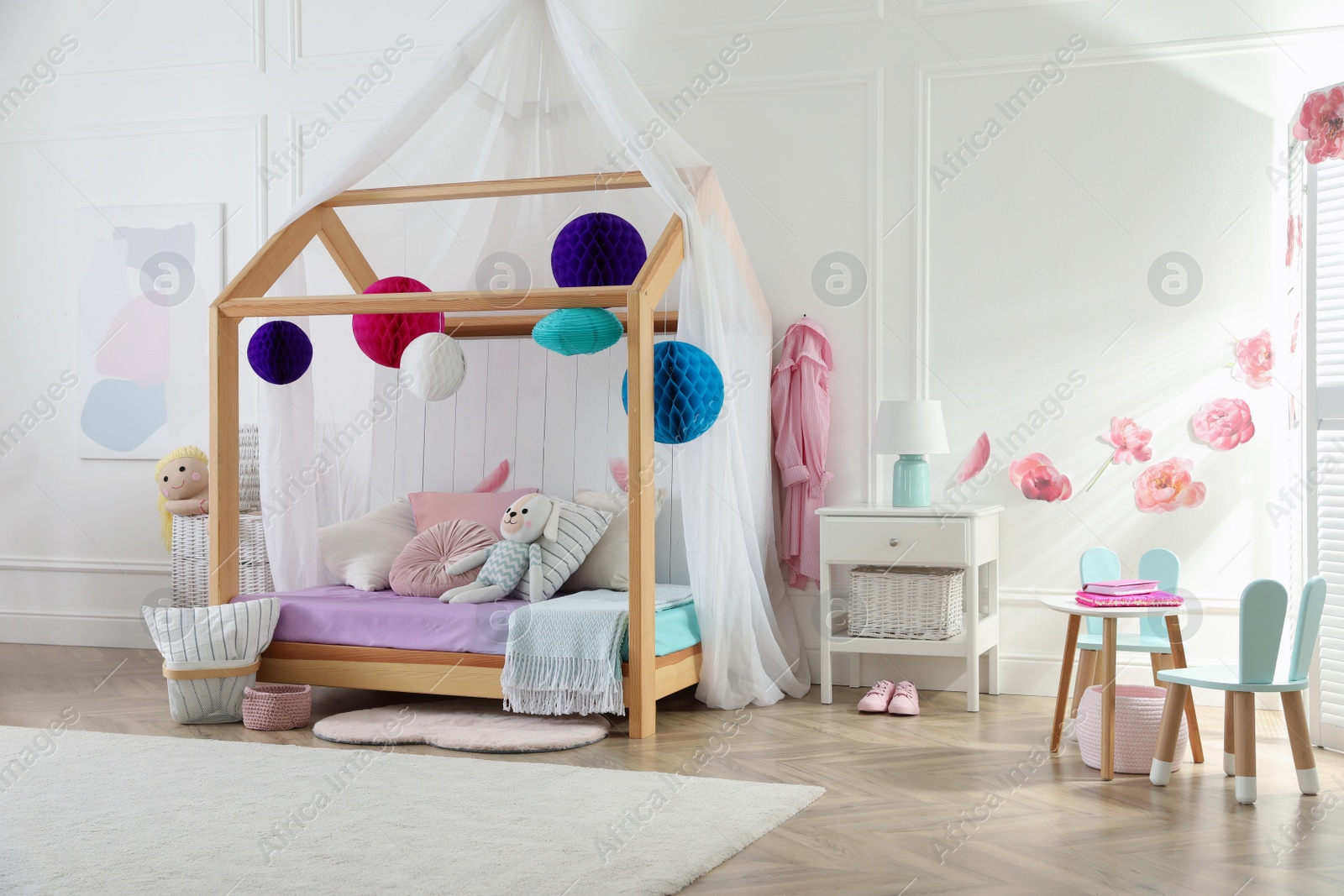 Photo of Stylish room for kid with house bed. Interior design