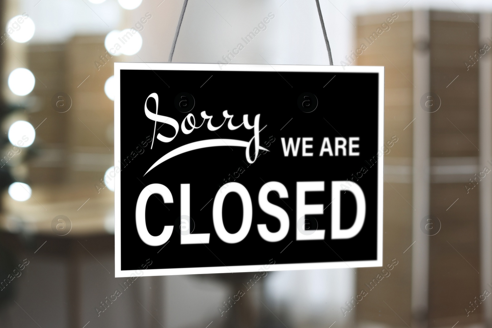 Image of Sorry we are closed sign against blurred background