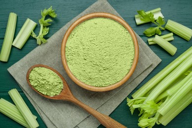 Photo of Natural celery powder and fresh stalks on green wooden table, flat lay