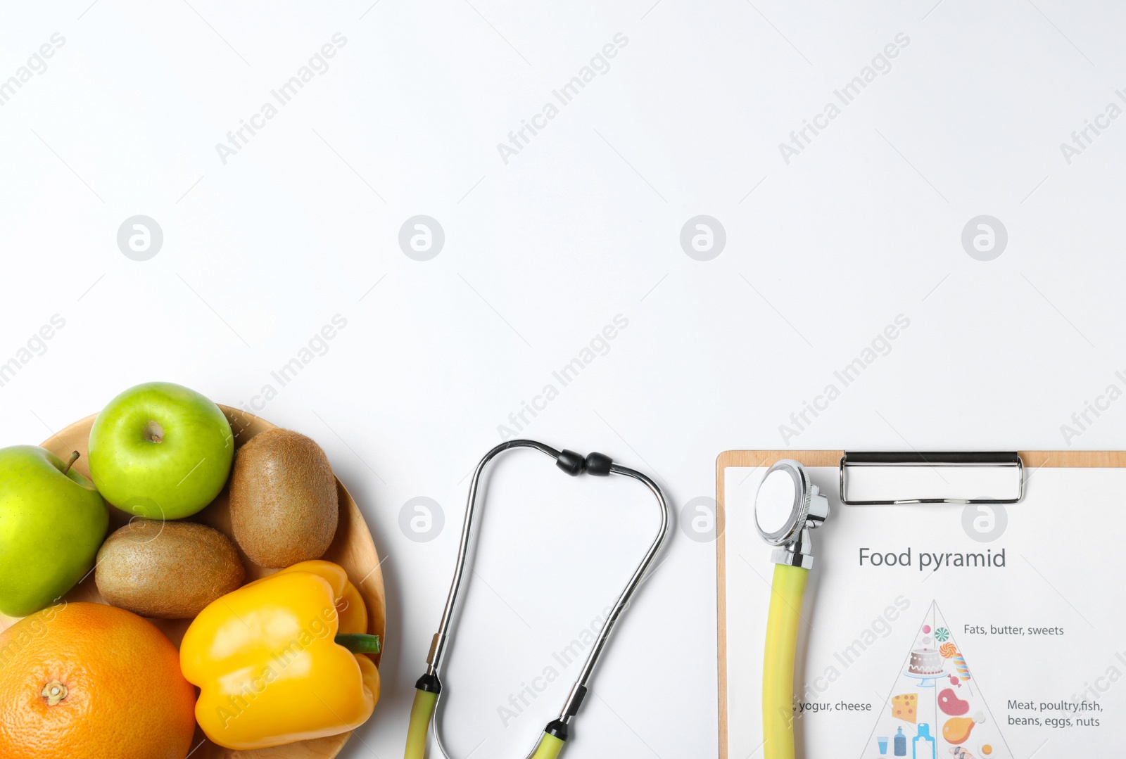 Photo of Fruits, vegetables, stethoscope and list of products on white background, top view. Visiting nutritionist