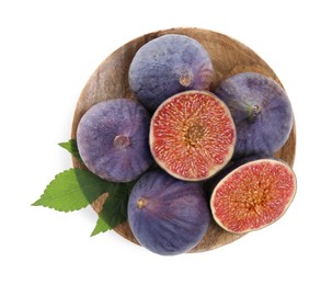 Wooden plate with whole and cut fresh purple figs isolated on white, top view