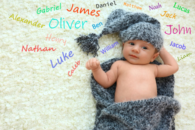 Choosing name for baby boy. Adorable newborn on soft blanket, view from above