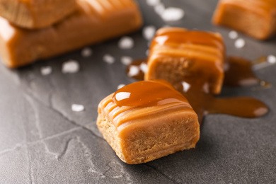 Photo of Salted caramel on grey table, closeup view