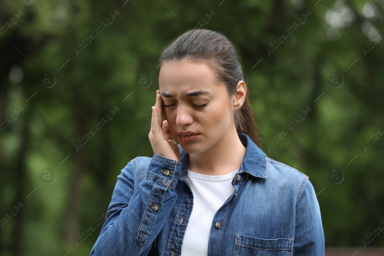 Photo of Woman suffering from seasonal spring allergy outdoors