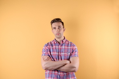 Handsome young man on color background