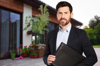 Image of Handsome real estate agent with portfolio near beautiful house outdoors. Space for text
