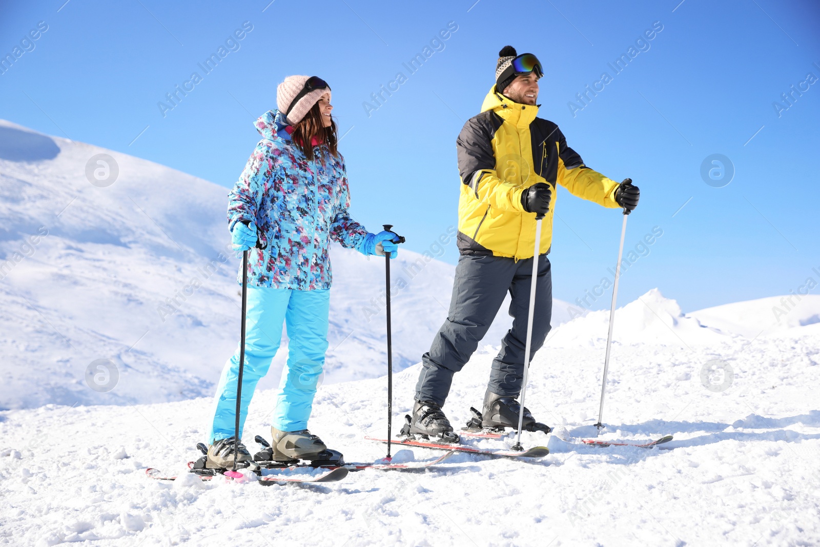 Photo of Young couple skiing on hill. Winter vacation