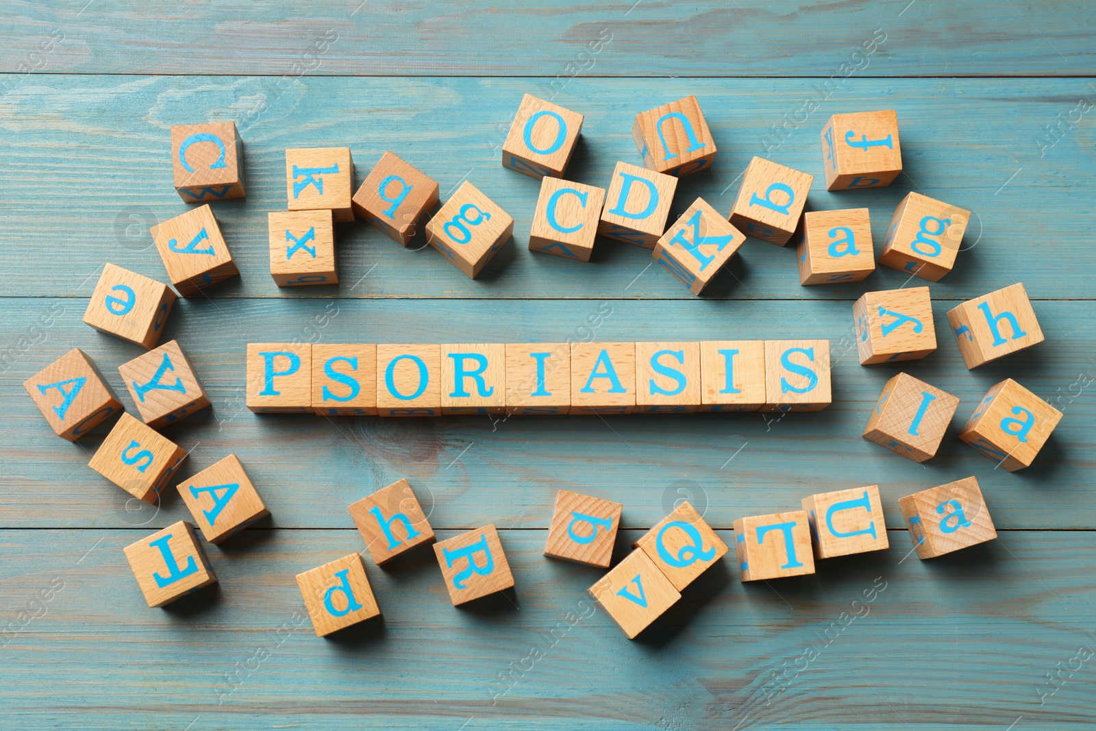 Photo of Word Psoriasis made of cubes with letters on wooden table, flat lay