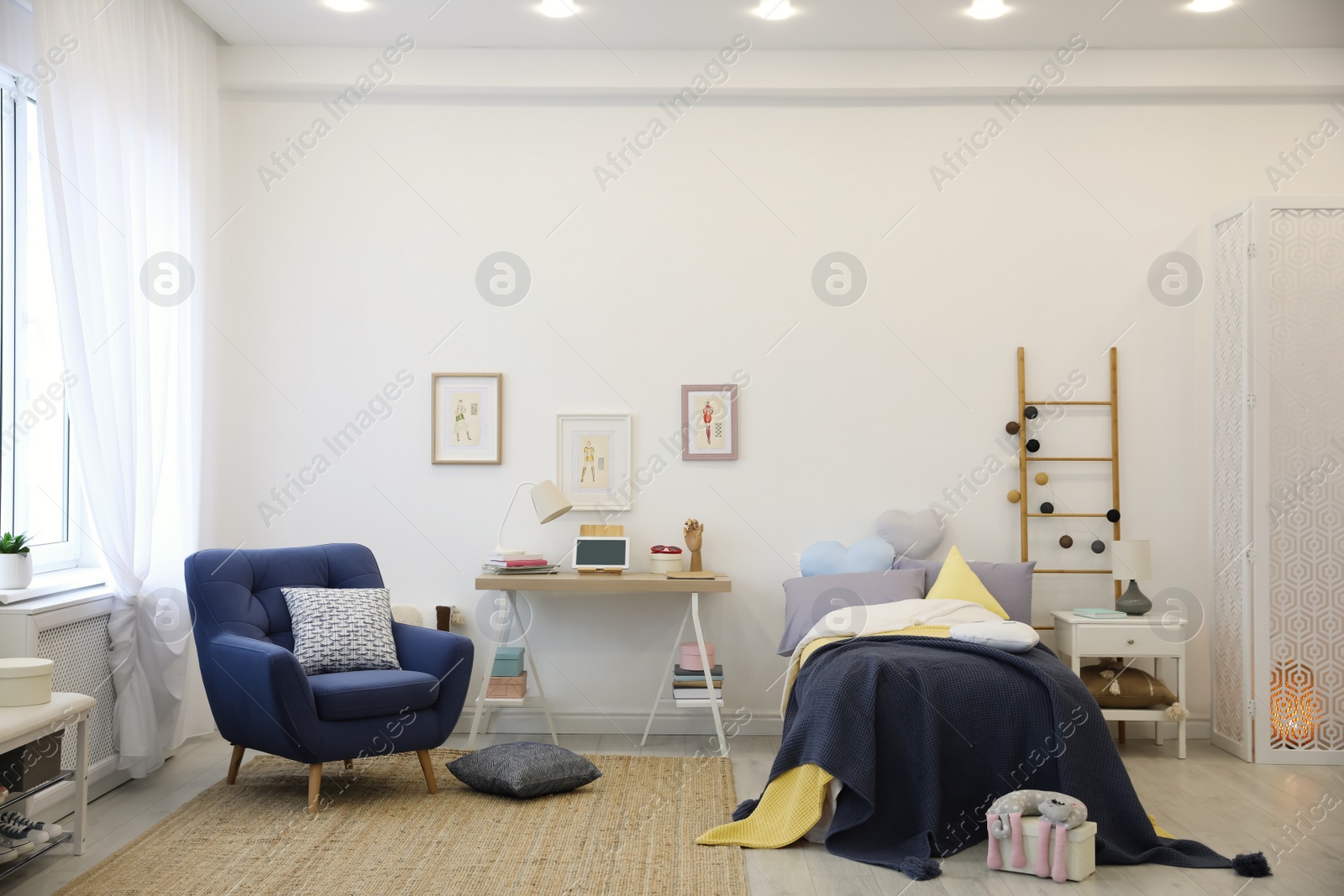 Photo of Modern teenager's room interior with bed and armchair