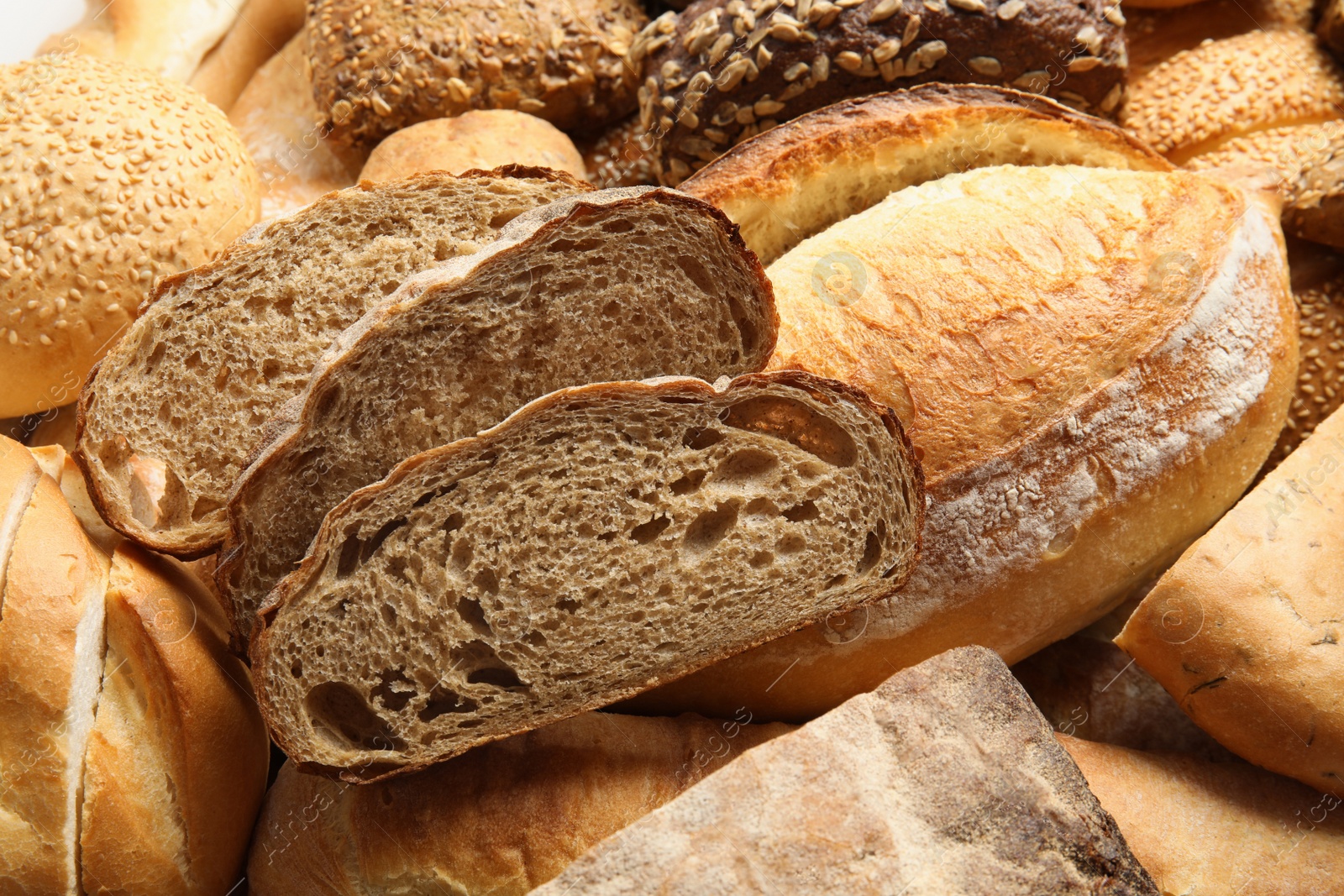 Photo of Different kinds of bread as background, closeup