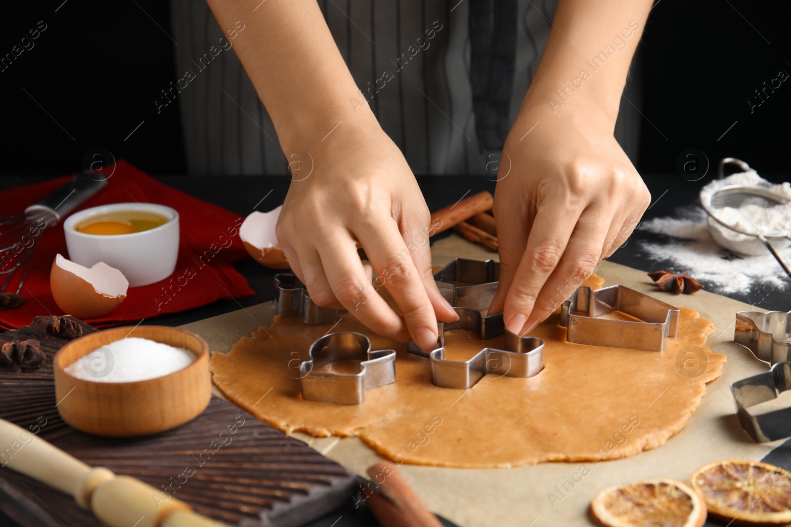 Photo of Woman making Christmas cookies at table, closeup