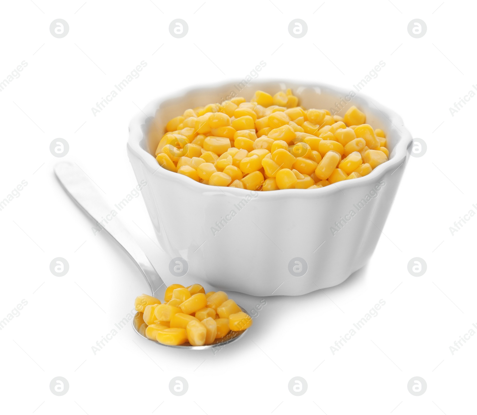 Photo of Bowl and spoon with corn kernels on white background