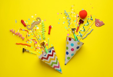 Photo of Beautiful flat lay composition with festive items on yellow background. Surprise party concept