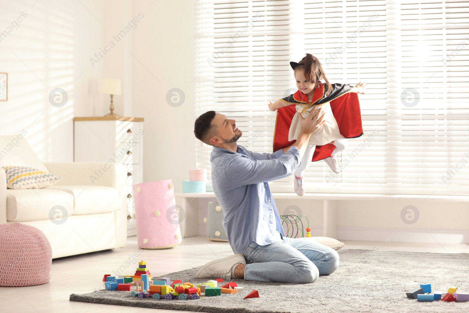 Photo of Father playing with his child at home