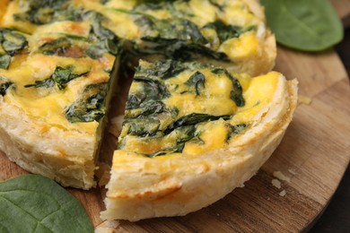 Photo of Delicious pie with spinach on table, closeup