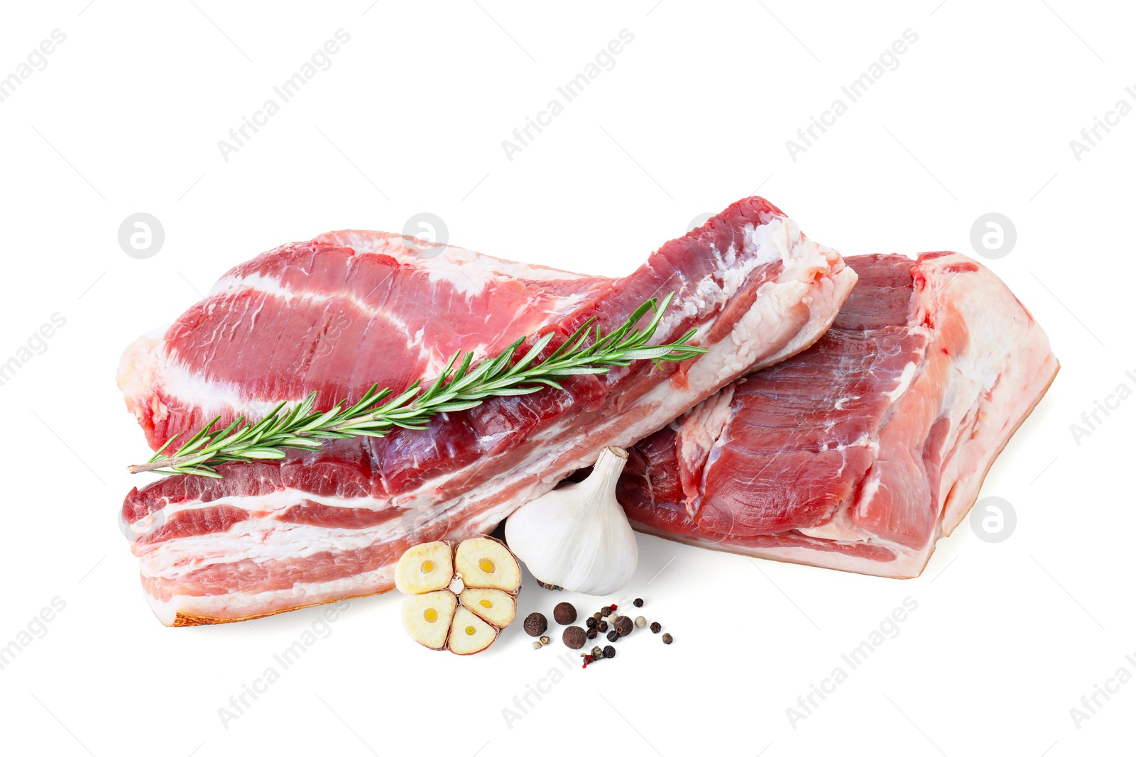 Photo of Pieces of raw pork belly, garlic, rosemary and peppercorns isolated on white