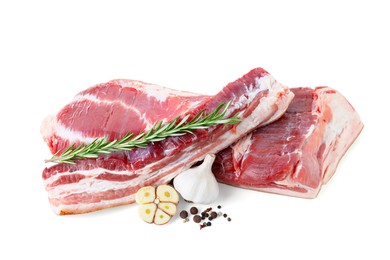 Photo of Pieces of raw pork belly, garlic, rosemary and peppercorns isolated on white