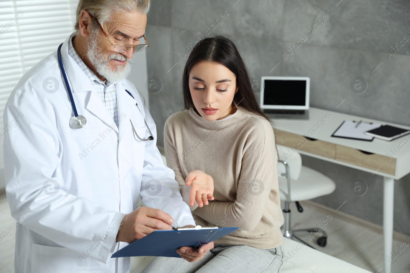 Photo of Patient having appointment with senior doctor in clinic