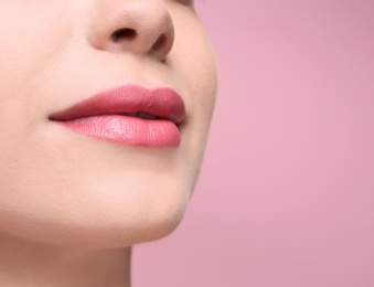 Photo of Beautiful young woman with perfect lips makeup on color background, closeup