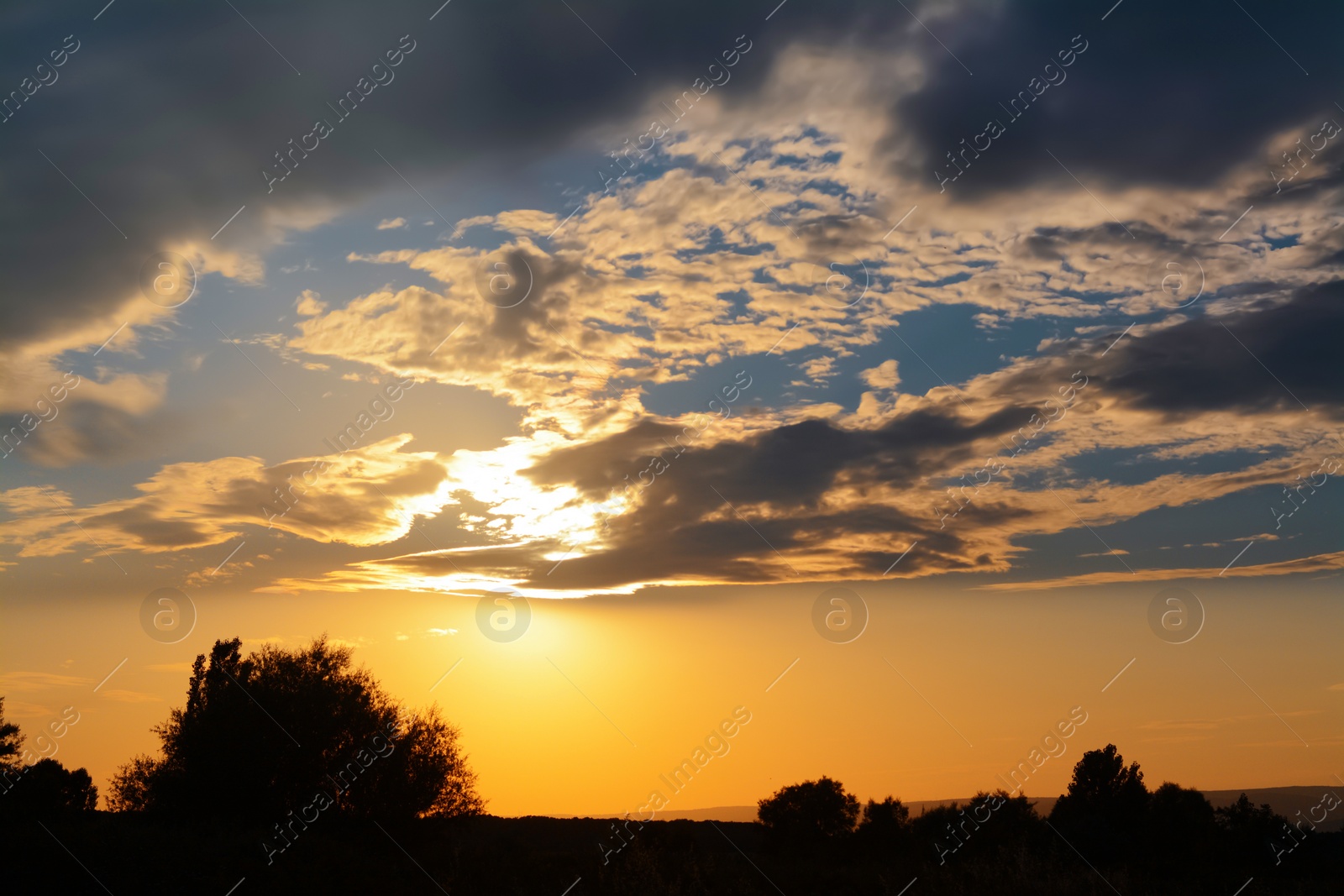 Photo of Picturesque view of landscape under beautiful evening sky with clouds at sunset