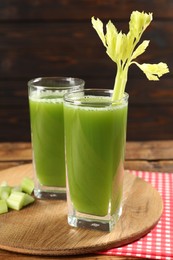 Photo of Celery juice and fresh vegetable on table, closeup