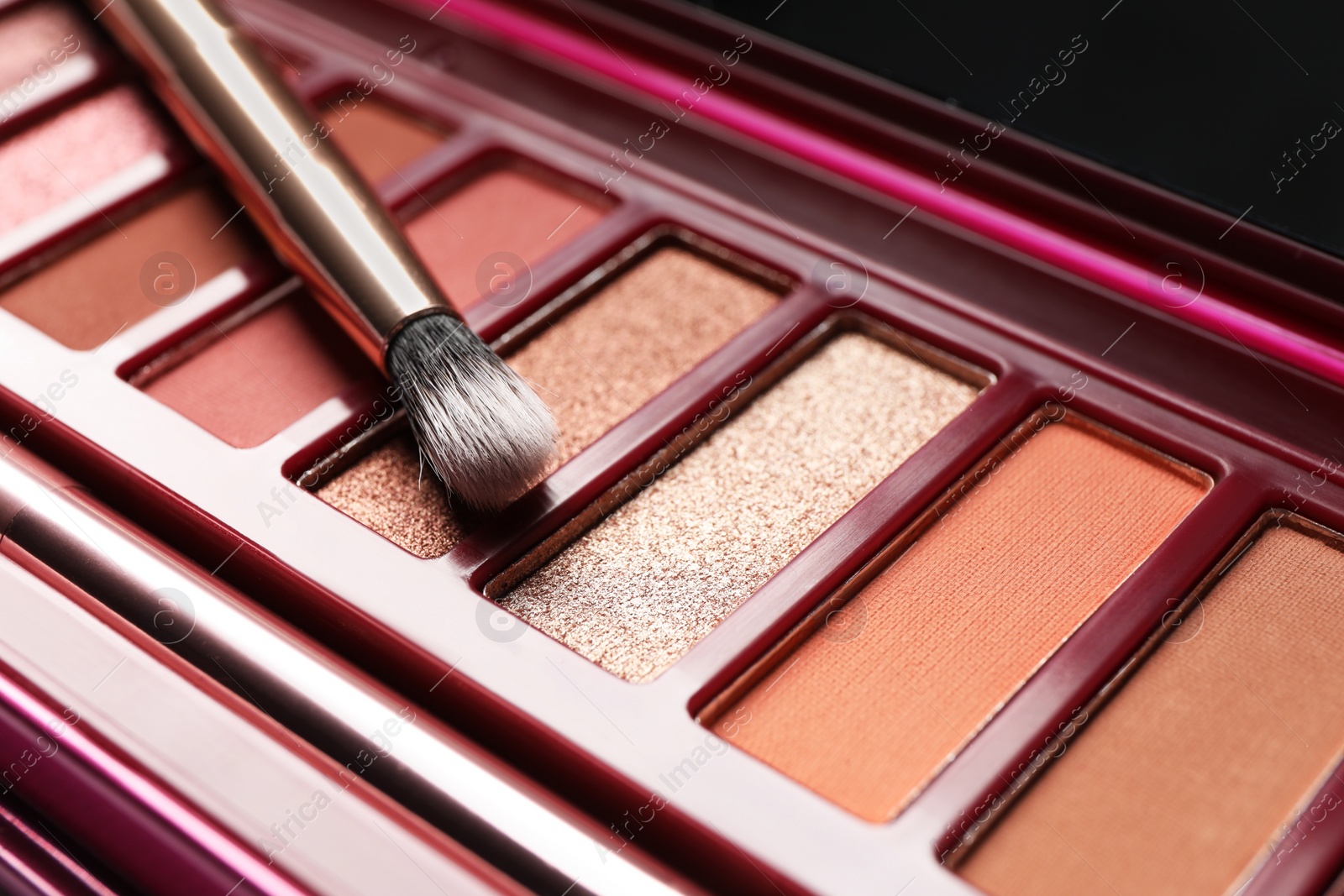 Photo of Beautiful eye shadow palette and brush, closeup view