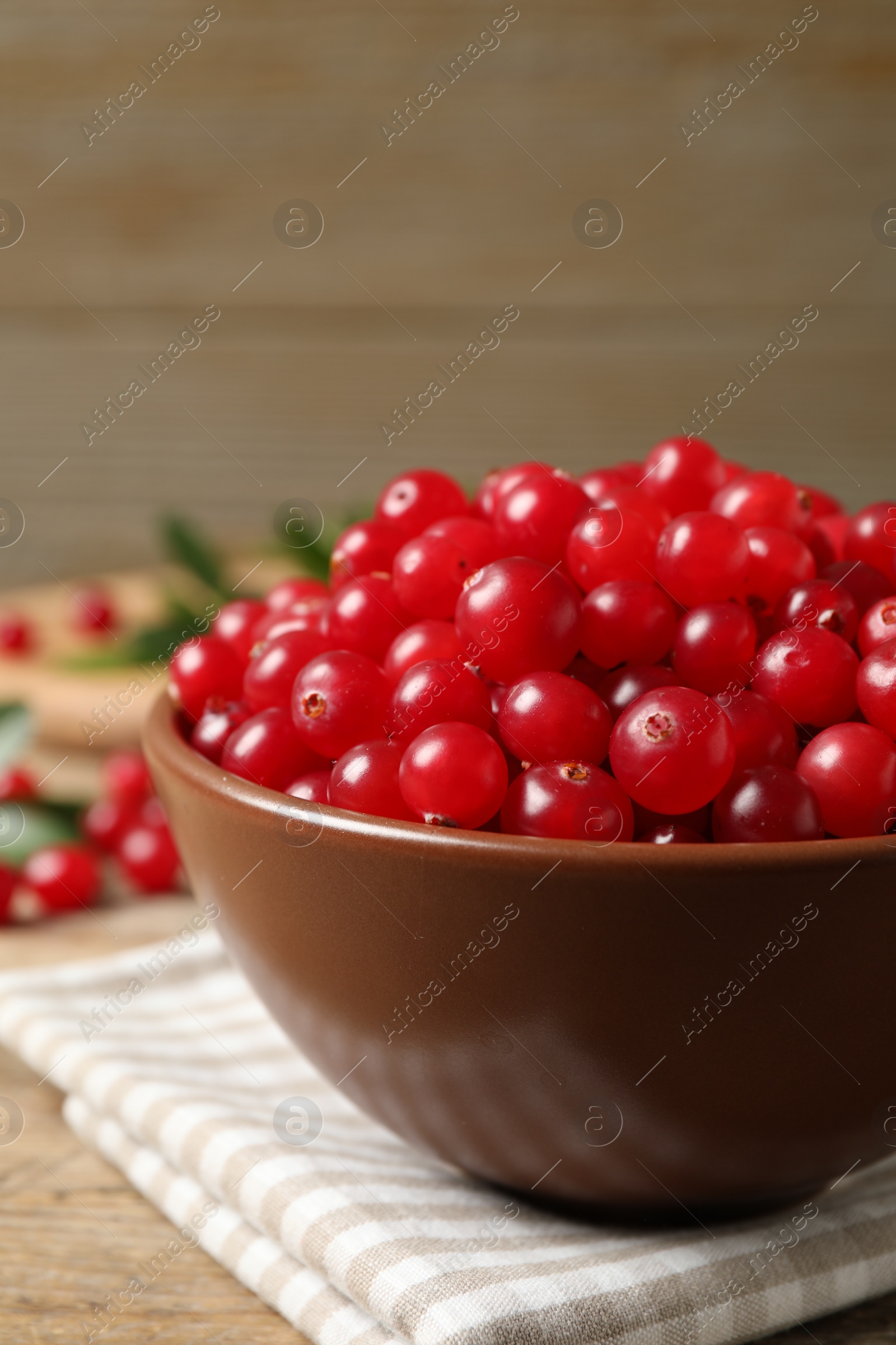 Photo of Tasty ripe cranberries on wooden table, closeup